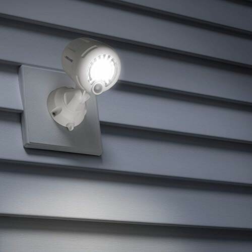 Outdoor motion sensor security light on siding.