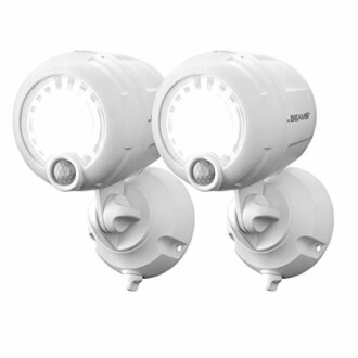 Pair of white wireless motion sensor lights with mounting bases.